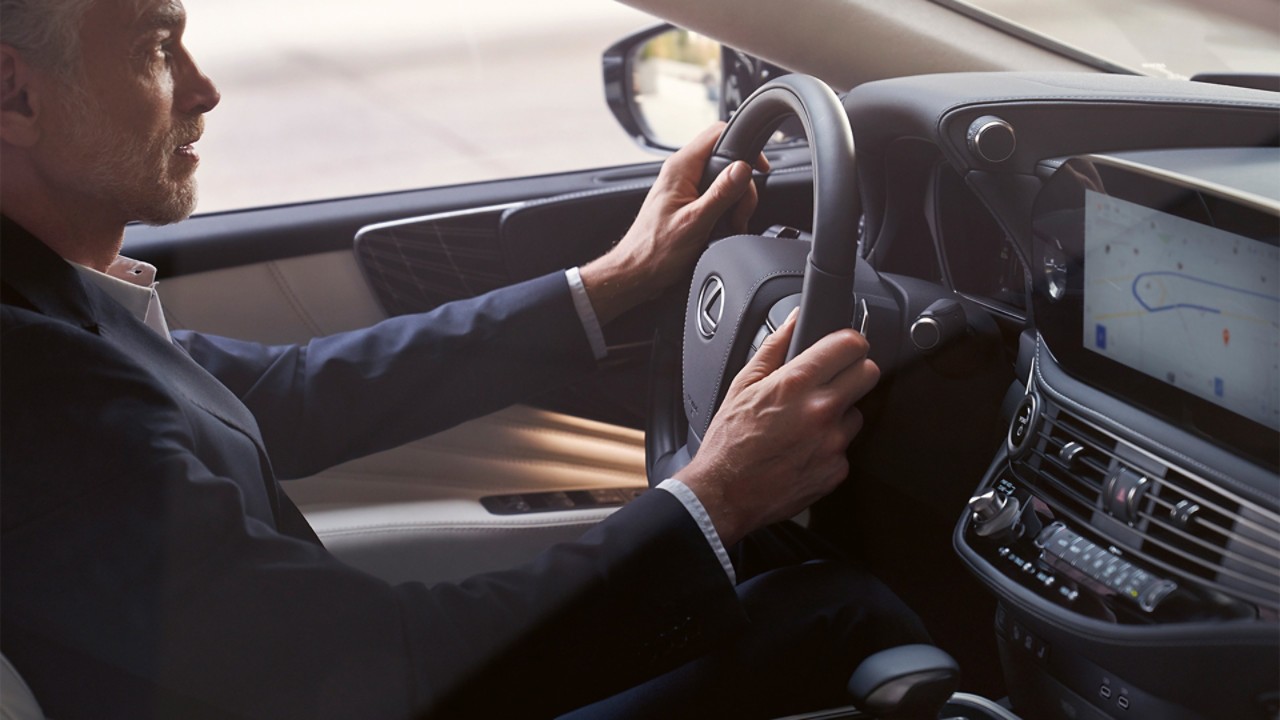 A man driving a Lexus LS