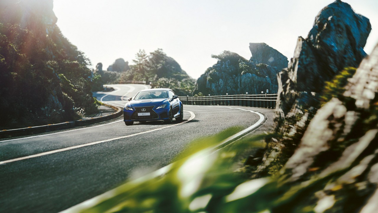 The Lexus RC F driving on a mountain road