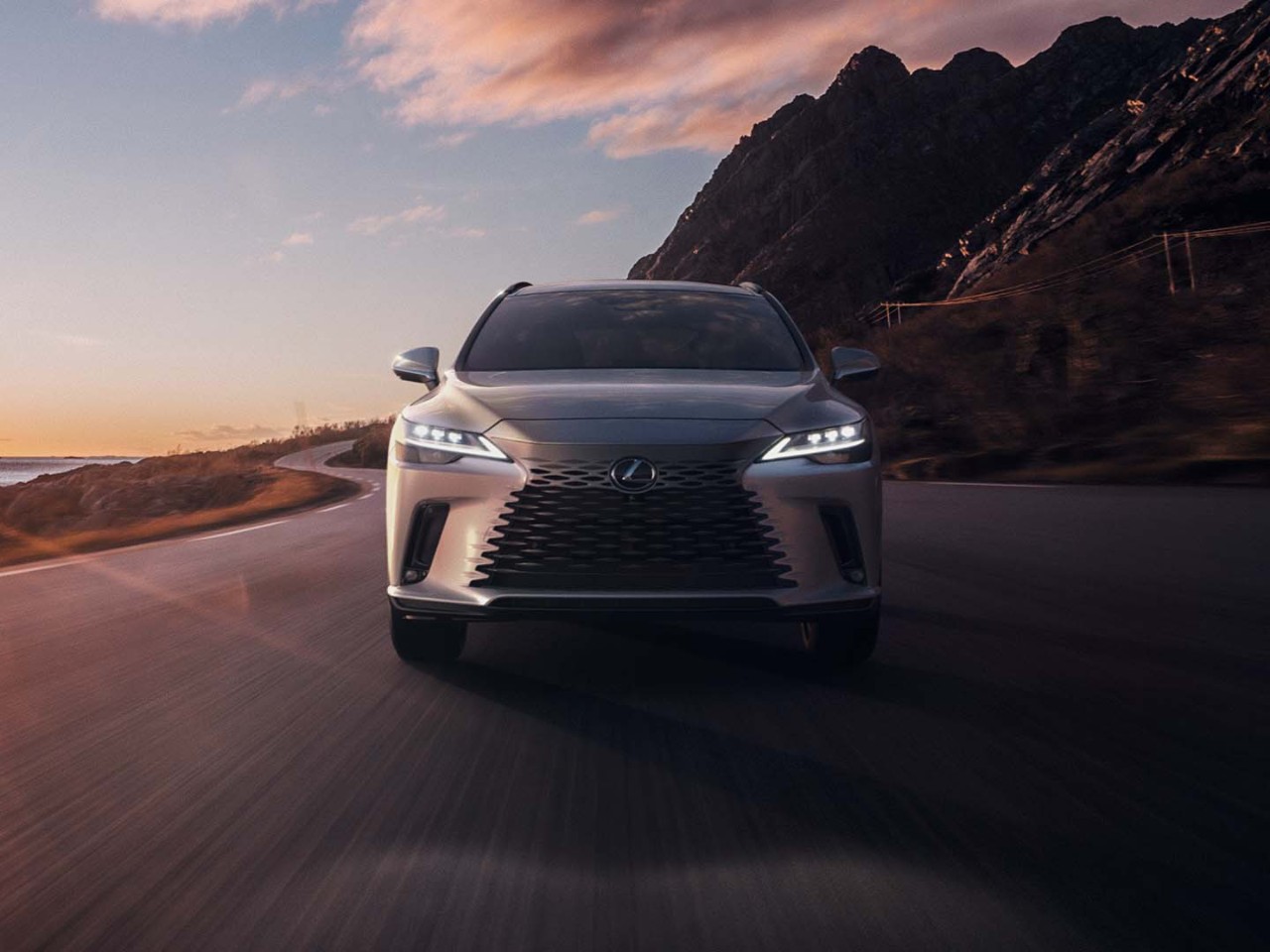 A Lexus RX 350h driving on a coastal road