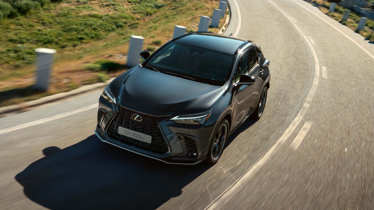 A Lexus NX 450h+ driving on a road