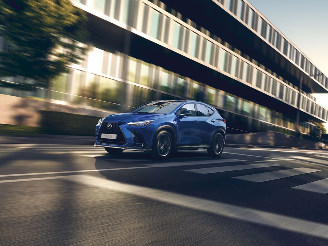 A Lexus NX 450h+ driving on a road