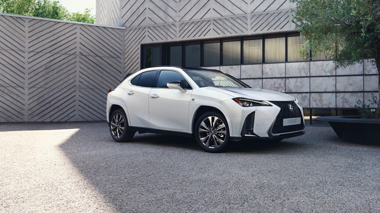 A white Lexus outside a building